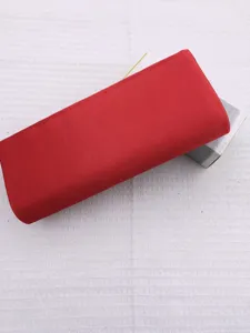 Detailed view of a stylish red pleated evening clutch bag, elegant accessory for events.