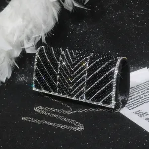 Elegant black beaded evening clutch bag with sparkling rhinestones and silver chain strap.