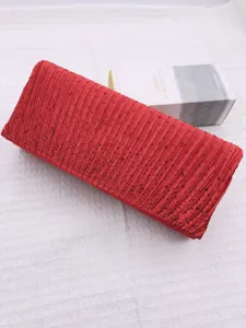 Red pleated evening clutch bag detail featuring sparkling rhinestones and water drop decorations.