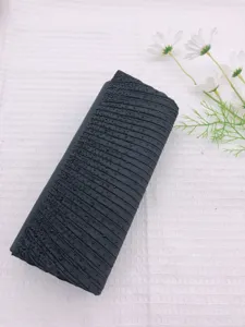 Detailed view of a black pleated rhinestone evening clutch bag with delicate sparkling crystal dots.