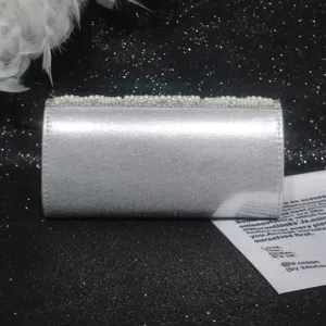 Silver rhinestone evening clutch bag detail, elegant pearl embellished party shoulder bag.