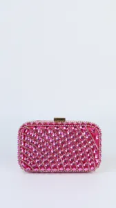 Pink rhinestone clutch bag detail, sparkling crystals in wave pattern with gold clasp.