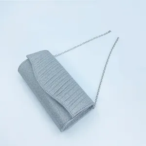 Silver glitter pleated evening bag with chain strap, elegant clutch for party and wedding events.