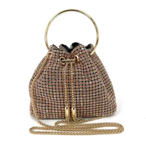 Sparkling rhinestone detail view of the elegant evening bag with gold metal ring and chain strap.