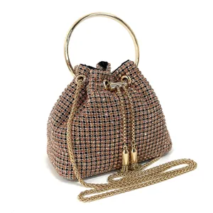 Elegant rhinestone bucket evening bag with gold ring handle and chain strap for women.