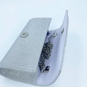 Silver glitter evening clutch bag with chain strap and magnetic snap closure for party women.