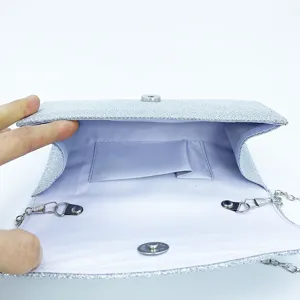 Silver glitter evening clutch bag interior detail, elegant party shoulder bag with chain.
