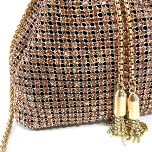 Close-up detail of luxury rhinestone evening bag with shimmering crystals and gold chain.
