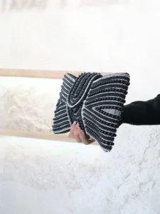 Elegant black beaded evening clutch bag detail view, shimmering rhinestones bow shape.