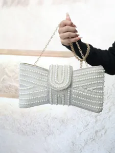 Elegant pearl beaded evening clutch bag with bow design, glamorous shoulder bag.