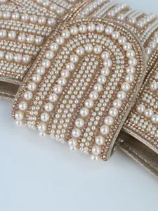 Stunning close-up detail of luxurious faux pearls and rhinestones on the evening bag.