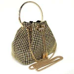 Sparkling gold rhinestone evening bag with metal ring handle and chic chain strap for women.