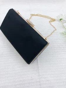 Black suede evening clutch bag with gold chain strap, elegant box design for women.