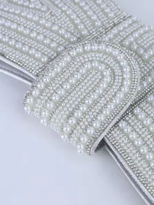 Close up of luxury pearl rhinestone evening bag clutch detail, elegant beaded banquet accessory.