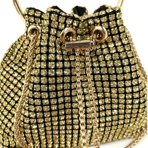 Close-up detail of luxury gold rhinestone evening bag with sparkling crystals and metal handle.
