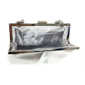Detail view of a silver evening clutch bag featuring a metallic frame and chain strap.