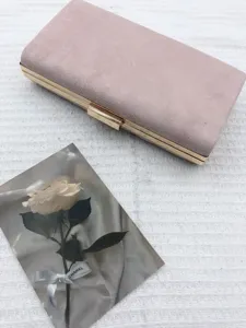 Pink suede evening clutch bag with elegant gold metal frame and secure clasp closure.