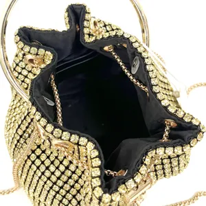 Sparkling gold rhinestone evening bag detail with chic metal ring handle and delicate chain.