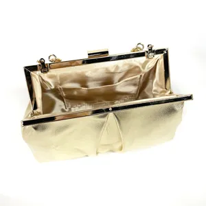 Gold evening clutch bag detail featuring metallic frame clasp, chain links, and inner pocket.