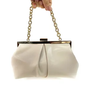 Close-up shot of the elegant ruched clutch with golden chain strap and clasp detail.