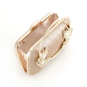 Detailed view of the sparkling gold rhinestone evening clutch bag with elegant metallic frame.