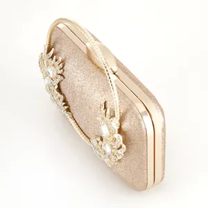 Gold glitter evening clutch bag with sparkling rhinestones and metal handle detail chic.