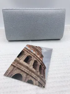 Silver glitter evening clutch detail view with textured finish and elegant party accessory look.