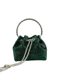 Detailed shot of sparkling green rhinestone evening bag with silver metal ring handle.