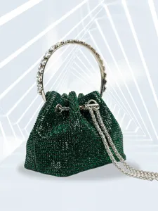 Detailed view of dark green rhinestone bucket bag with metal ring handle for party and evening.