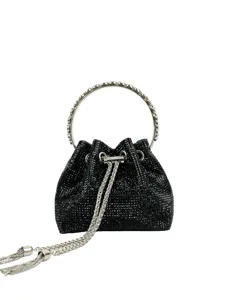 Close-up detail of the black rhinestone bucket bag with metal ring handle and chic chain strap.