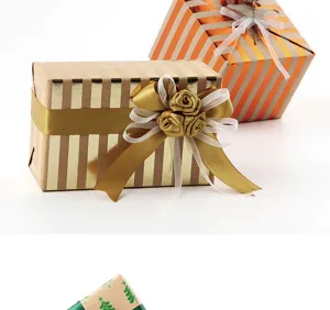 Vintage gold striped gift wrapping paper with satin bow decoration, perfect for Christmas.