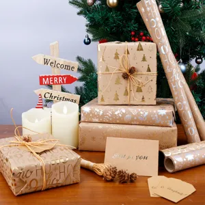 Christmas kraft wrapping paper roll set with festive gold prints and greeting cards.