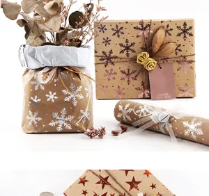 Vintage kraft gift wrapping paper with gold snowflake design for Christmas holiday and birthday.