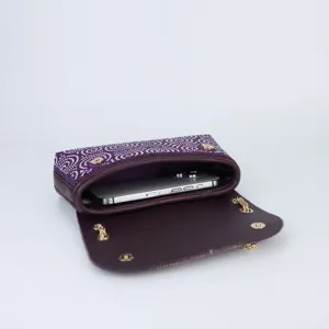 Close-up detail shot of a luxury purple rhinestone evening shoulder bag showing interior capacity.
