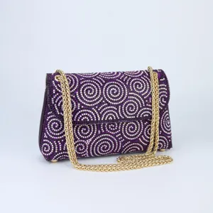 Stunning purple rhinestone shoulder bag with elegant gold chain strap for evening parties.