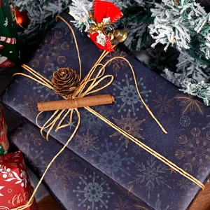 Christmas gift wrapping paper set with snowflake design, twine, pinecone and holiday bows.