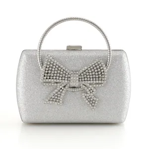 Exquisite silver glitter evening clutch bag featuring rhinestone bow and round metal handle.
