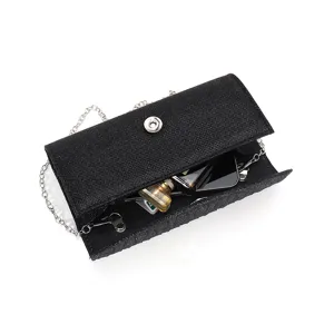 Detail view of the black glitter evening clutch bag interior and metallic chain strap structure.
