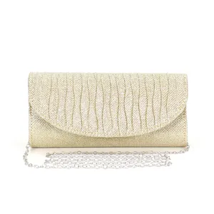 Gold glitter evening clutch bag detail showing sparkling fabric and silver chain strap.