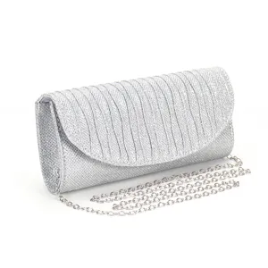 Close up view of the silver glitter evening clutch bag detail showing pleated flap design.