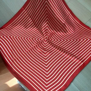 Detailed view of the red and white striped square silk scarf, perfect for neck or bag decoration.
