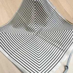Silk square scarf featuring a modern black and white geometric stripe design for women.