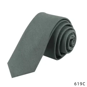 Detail close-up of a dark green solid cotton linen tie, showing fine fabric texture and neat roll.