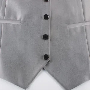 Close-up detail of a men grey suit vest showing fabric texture, black buttons and welt pocket.