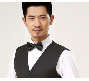 Close-up detail of a mens formal slim fit suit vest in black paired with crisp white shirt.