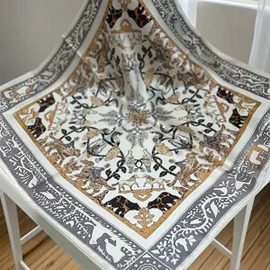 Detailed view of luxury silk square scarf with vintage animal pattern and elegant border style.