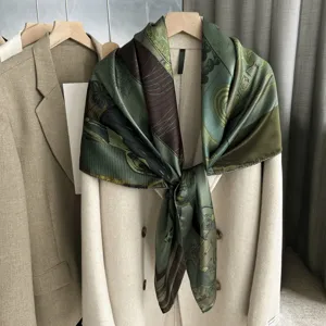 Detailed shot of the vintage printed silk square scarf draped gracefully over a classic coat.