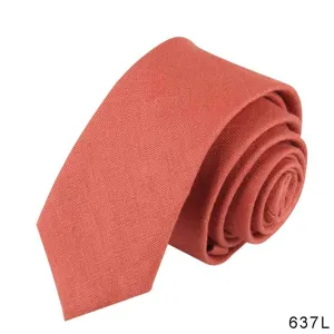 Detailed close-up view showing the fine linen texture of a rolled rust orange men necktie.