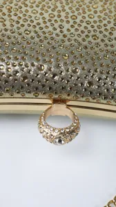 Sparkling gold rhinestone evening clutch bag with luxury ring handle clasp detail for party
