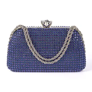 Detailed view of luxury blue rhinestone evening clutch bag with metallic chain and crystal clasp.